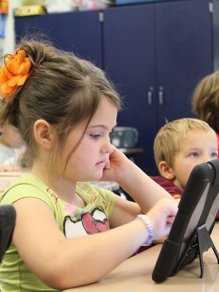 Young student using a tablet in class.